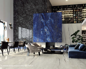 The off white, veined, polished floor is the perfect foundation for bold finishes in this open concept, modern space. The neutral finish is perfect for adding in pops of colour and dark tones. Large format porcelain tiles are used in multiple applications throughout the rooms. See all of these slab in the Edmonton showroom.