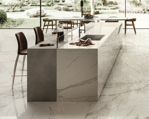 The custom island waterfall countertop combines two finishes of porcelain, creating an exclusive look for this kitchen space. See the large format tile at the showroom in Edmonton, Alberta. 