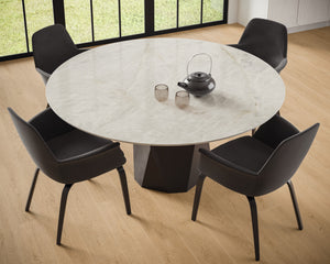 A round table custom fabricated from high quality porcelain makes a statement in the minimalist design. The distributor of the product is near me. 
