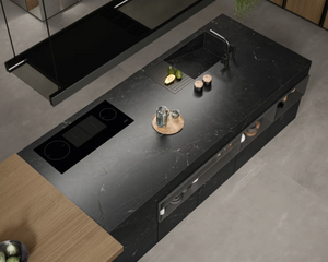 The large format porcelain slab creates a seamless, premium surface that is durable and heat resistant. The custom shelving in the island creates added storage. The distributor is in Edmonton. 