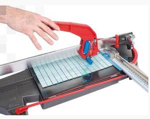 A Mosakit rubber mosaic cutting pad by Montolit, in a tile cutter tool, cutting a mosaic tile.